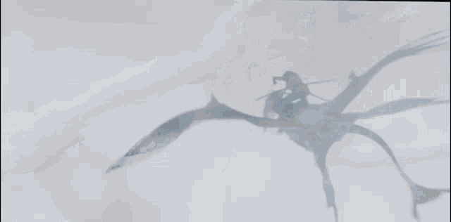 a person is flying through the air on a giant flying object .