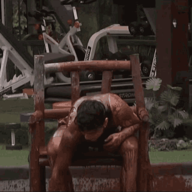 a man is sitting in a chair with a treadmill in the background that says strom