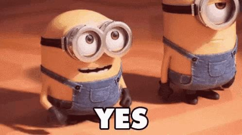 two minions wearing goggles and overalls are standing next to each other and the word yes is on the floor .