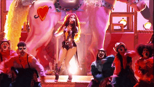 a woman in a cowboy outfit is standing in front of a pink horse with a heart on it