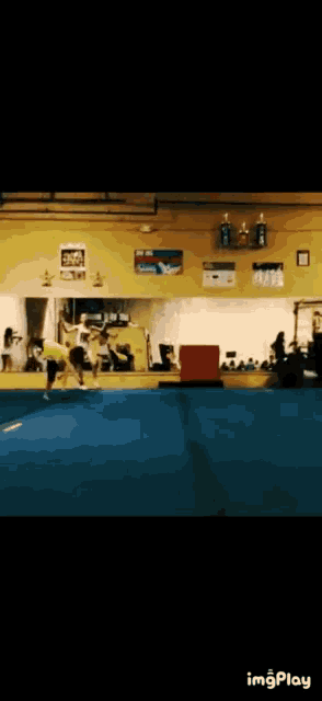 a gif of a person doing a trick in a gym with the words imgplay below it