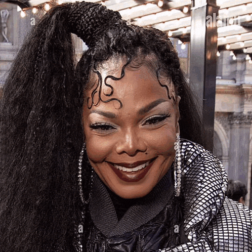 a close up of a woman 's face with a braided ponytail and the letter a on her forehead
