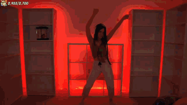 a woman is dancing in a room with a santa claus on the wall
