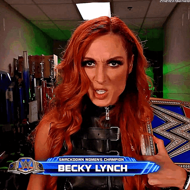 a woman holding a smackdown women 's champion belt