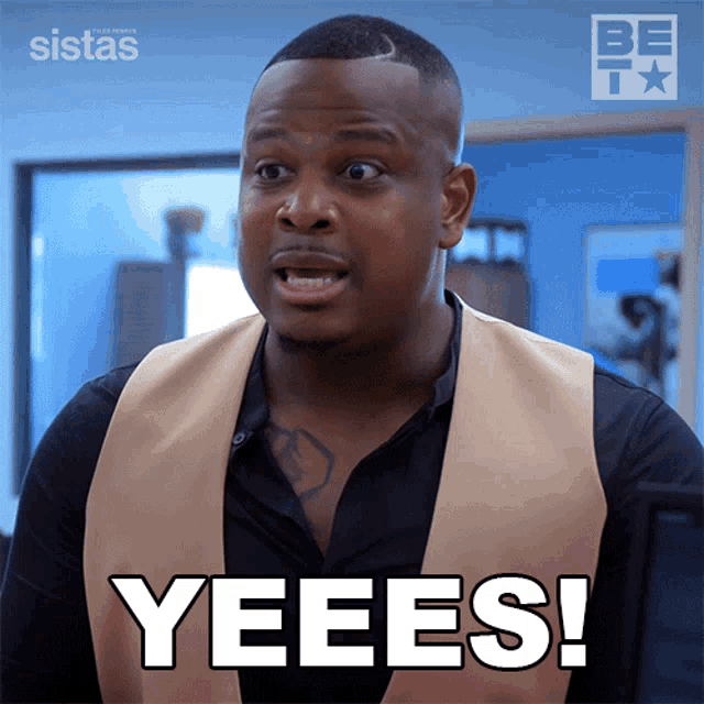 a man in a tan vest says yeees on a screen