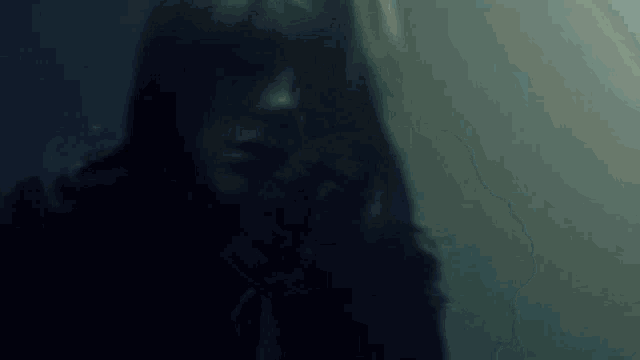 a silhouette of a woman in a dark room