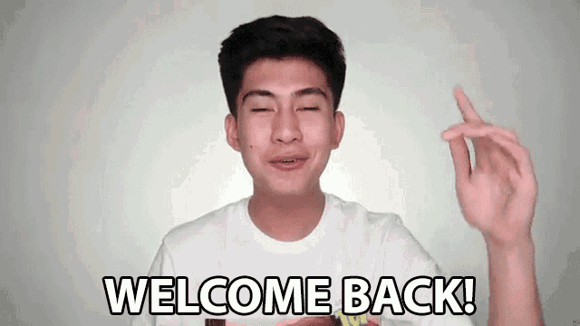 a young man in a white shirt is making a funny face and says welcome back .
