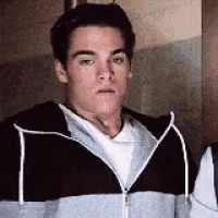 a young man wearing a hoodie and a white shirt is standing next to another young man .