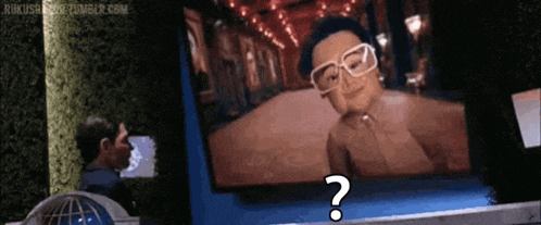 a man is looking at a picture of a woman with glasses and a question mark in front of it
