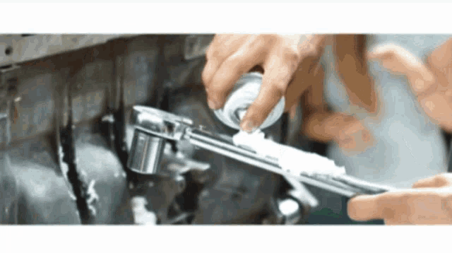 a close up of a person using a wrench to fix something