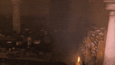 a man holding a candle in front of a group of children