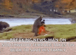 a bear is standing on its hind legs holding a person .