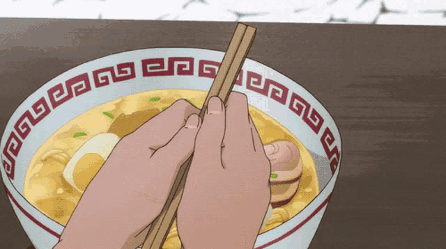 a person is holding chopsticks over a bowl of ramen with a red and white border