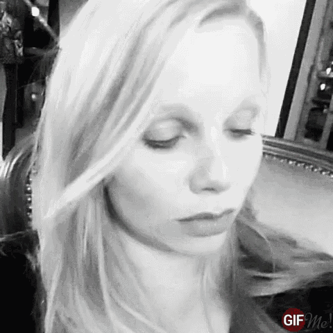 a woman 's face is shown in a black and white photo with a gif me logo in the lower right corner