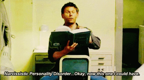 a man sitting in a chair reading a book with the words narcissistic personality disorder okay now this one i could have