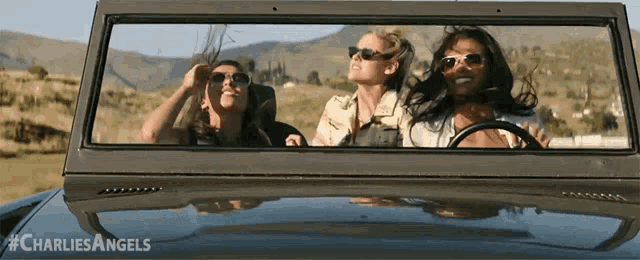 three women are looking out the window of a car with the hashtag charlie angels