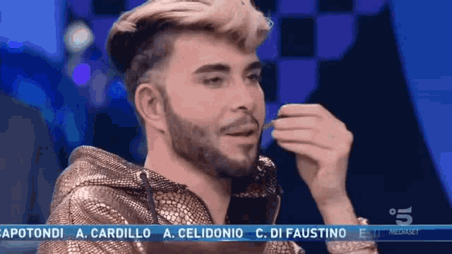 a man with a beard is on a television screen with the name capotondi on it