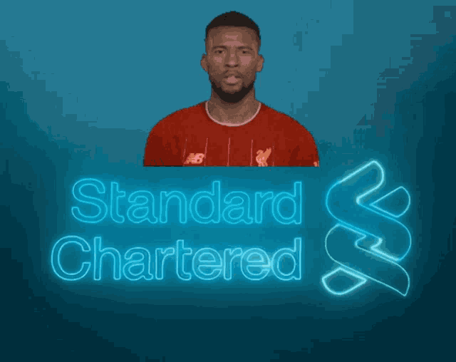 a man is screaming in front of a standard chartered sign