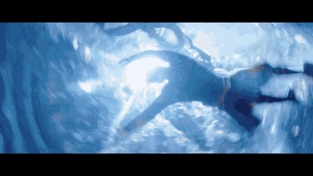 a blurry picture of a person swimming in a body of water