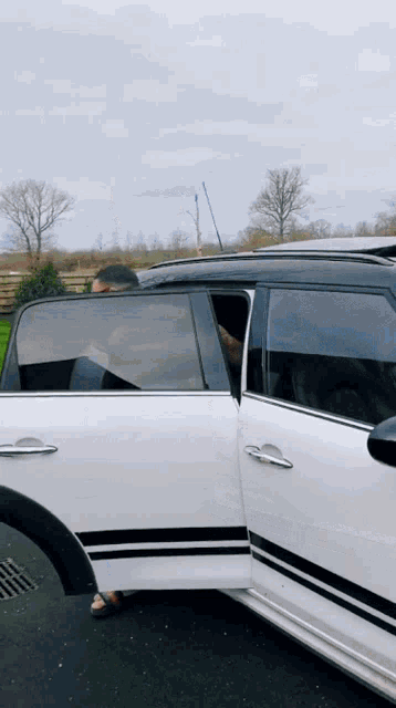 a white car with black stripes on the side