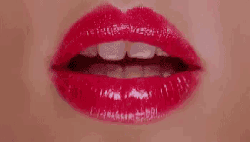 a close up of a woman 's lips with red lipstick and the words `` te mando un beso '' below it .