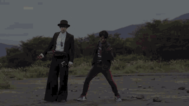 a man in a suit and top hat stands next to another man in a black jacket
