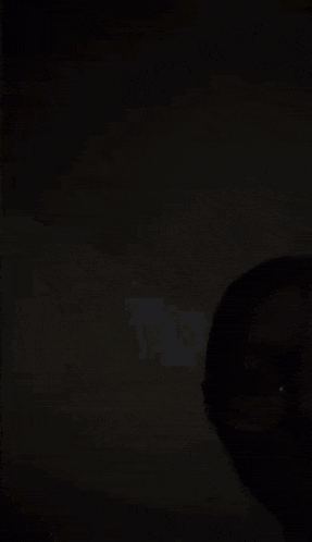 a person is standing in the dark with the words `` hi '' written in white .