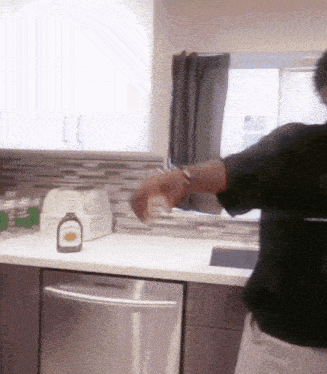 a bottle of maple syrup sits on a kitchen counter