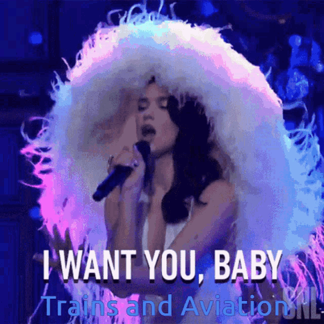 a woman singing into a microphone with the words " i want you baby " above her