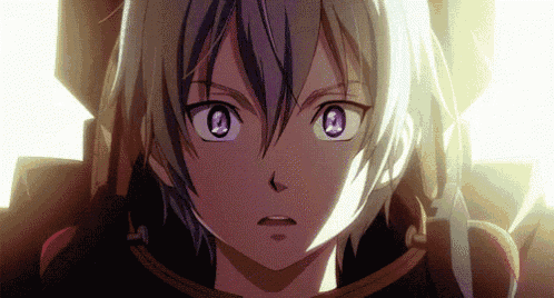 a close up of a person 's face with purple eyes and a surprised look on their face .