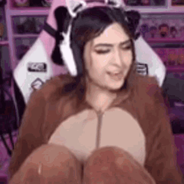 a woman in a teddy bear costume is sitting in a chair with her eyes closed .