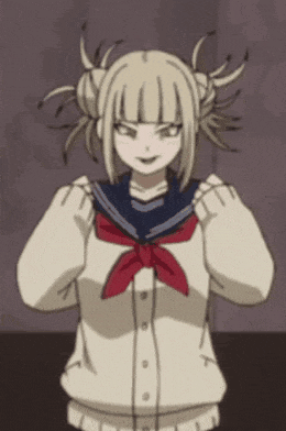 a girl with blonde hair and a red scarf is wearing a sailor uniform .