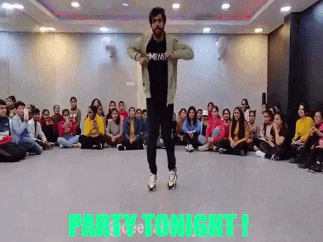 a man is dancing in front of a group of people with the words party tonight written above him