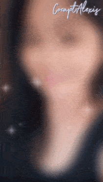 a blurry picture of a woman 's face with the name cocapt alexis above her