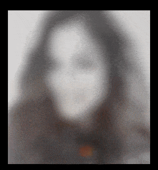 a blurry picture of a woman 's face with a gray background
