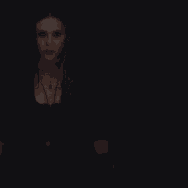 scarlet witch is holding a red light in her hands in a dark room .