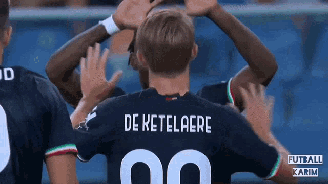 a soccer player named de ketelaere is surrounded by his teammates