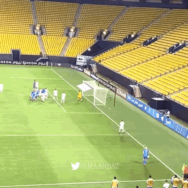 a soccer game is being played in an empty stadium with a twitter logo in the upper right corner