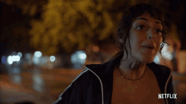 a woman is standing in front of a sign that says netflix on it