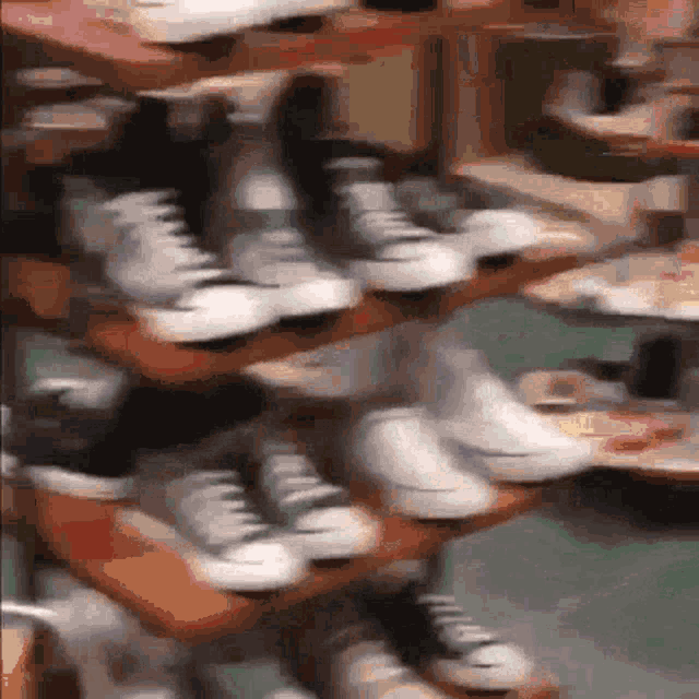 a bunch of shoes are stacked on top of each other on a rack