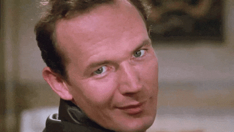 a close up of a man 's face with a slight smile on it .