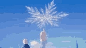a man and a woman are standing in front of a snowflake shaped cloud in the sky .
