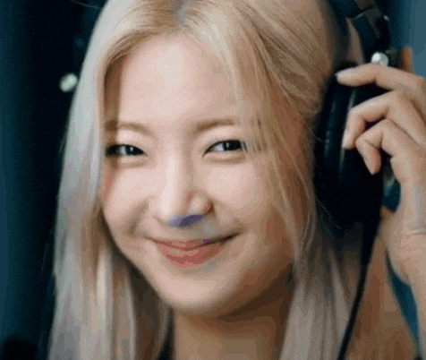 a close up of a woman wearing headphones smiling