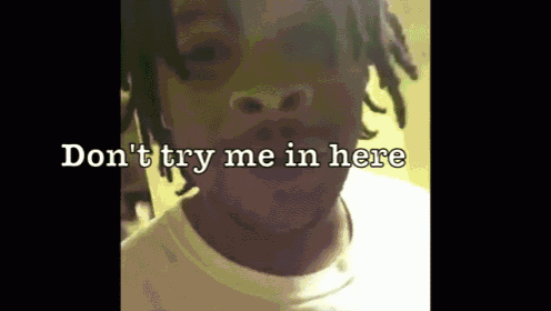 a close up of a person 's face with the words " don 't try me in here " written above it