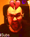 a man with glasses and a broken heart on his head is sitting in a chair .