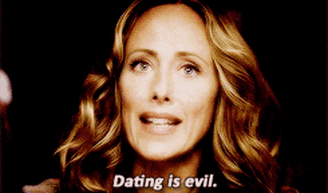 a woman says dating is evil in a dark room .