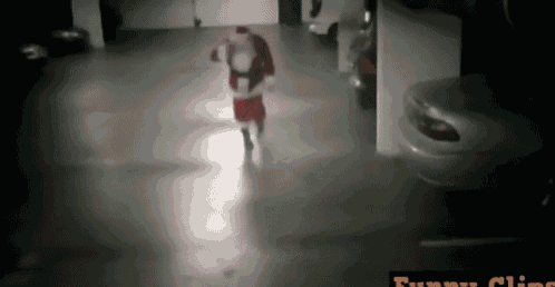 santa claus is walking through a parking garage with funny clips written on the bottom right corner