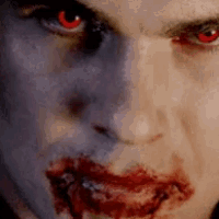 a close up of a vampire with blood on his face .