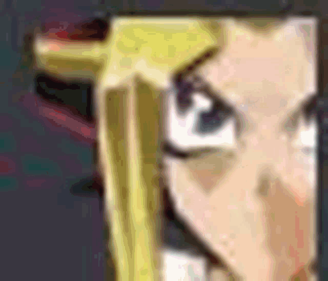 a close up of a cartoon character 's face with a gun .