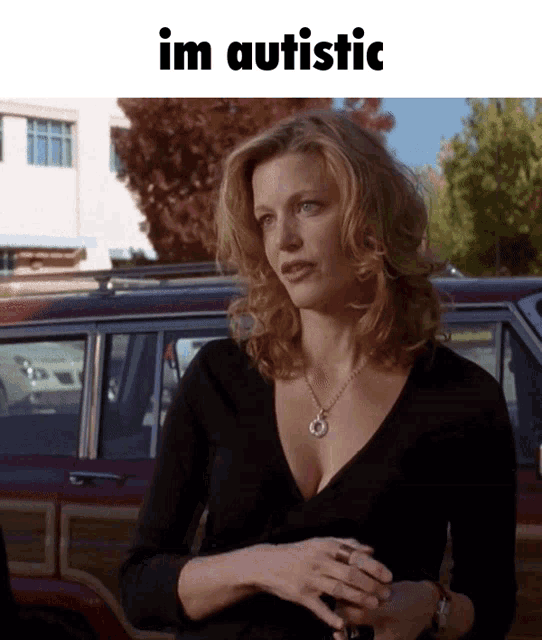 a woman standing in front of a red car with the words im autistic above her
